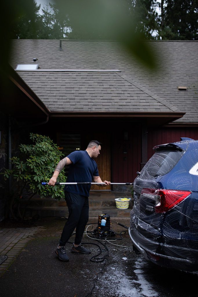 Jeff Crone washing exterior of vehicle